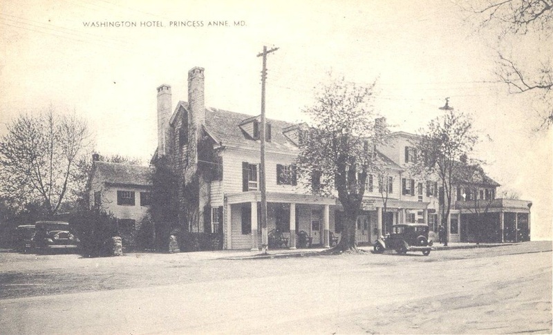 Washington Hotel in Princess Anne, sepia image of three story building with porch, forground is a dirt lane