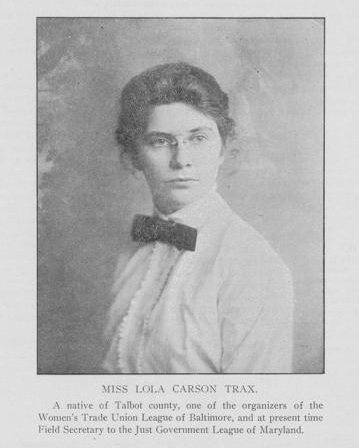 black and white image of a woman wearing wire rimmed glasses in a white collared shirt with a dark bowtie. Identified as Lola Carson Trax