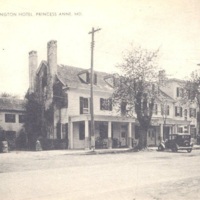 Washington Hotel in Princess Anne, sepia image of three story building with porch, forground is a dirt lane Washington Hotel in Princess Anne, sepia image of three story building with porch, forground is a dirt lane